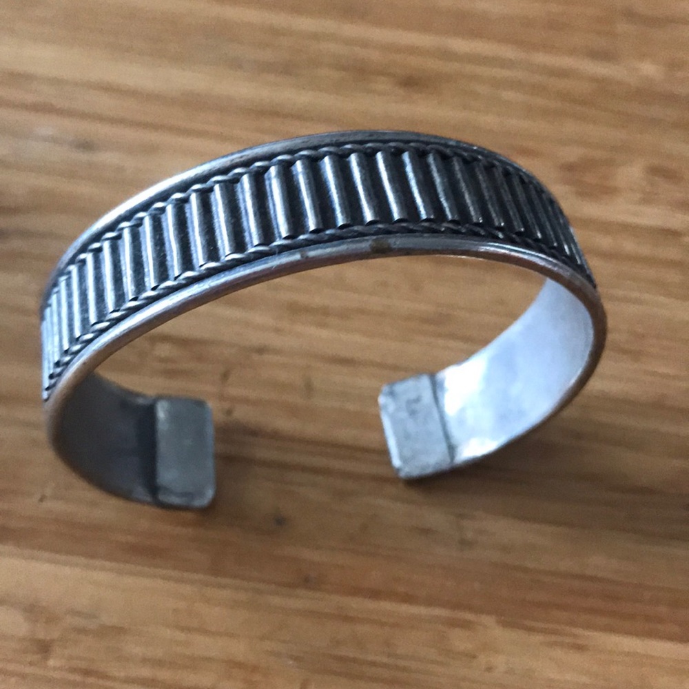 Silver colored metal adjustable bangle